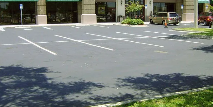 Well-maintained, freshly striped parking lot with cones